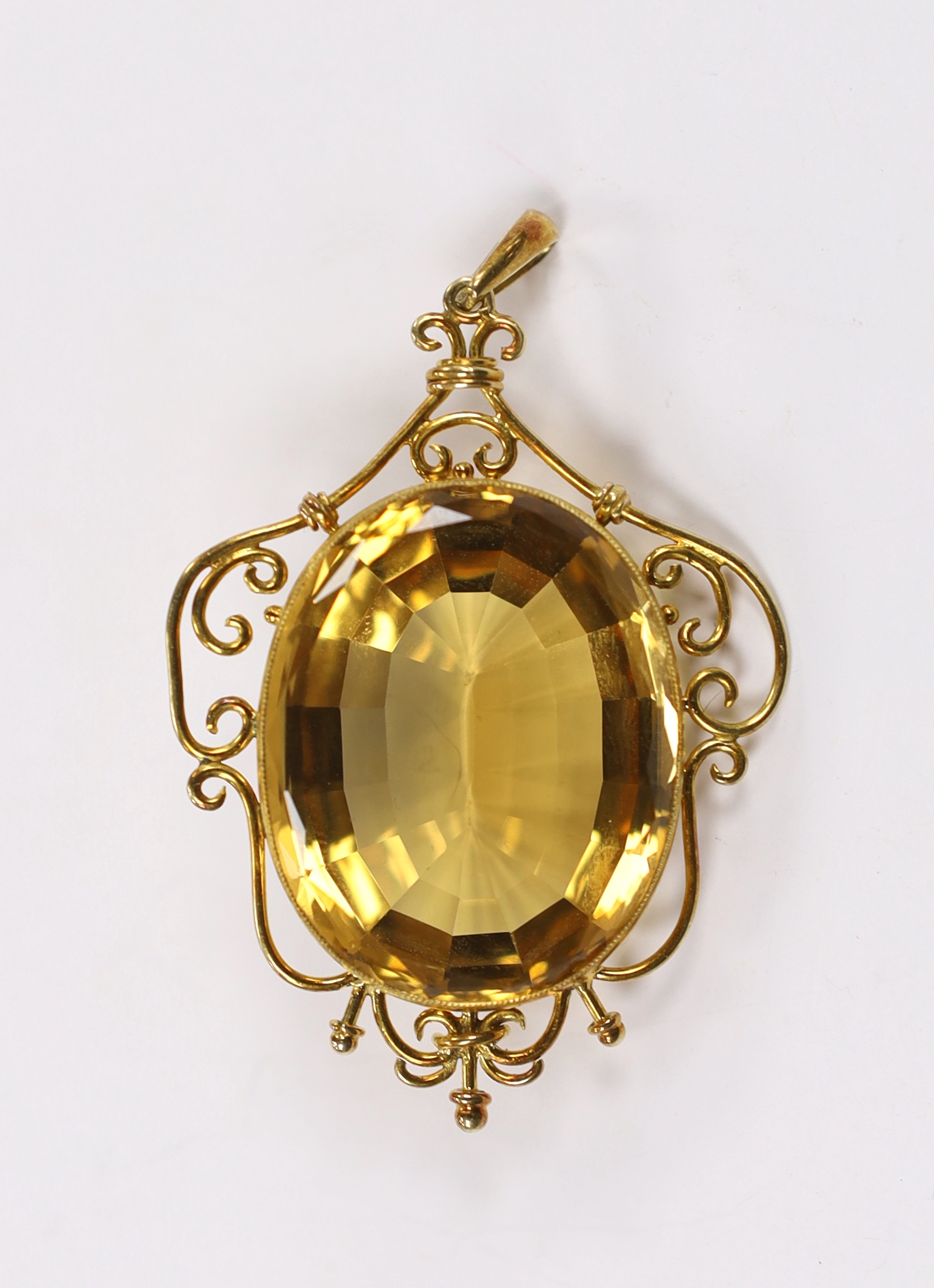 A yellow metal mounted oval cut citrine pendant, overall 56mm, gross weight 15.8 grams.